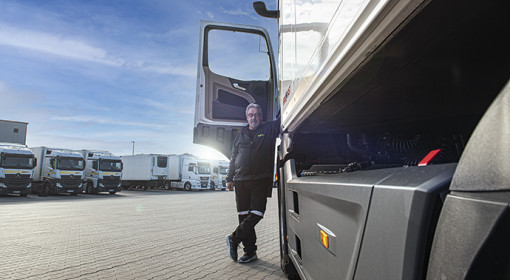 Mann lehnt an den LKW mit offener Fahrertür